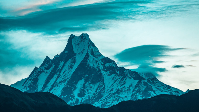 snow covered mountain under cloudy sky during daytime